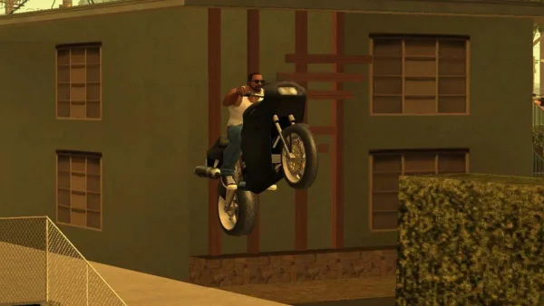 MOD APK 9 A character from a video game performing a motorbike stunt near a building.