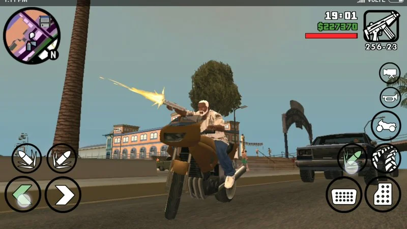 MOD APK 5 A character rides a motorcycle on a street, shooting a gun while buildings and palm trees are in the background.